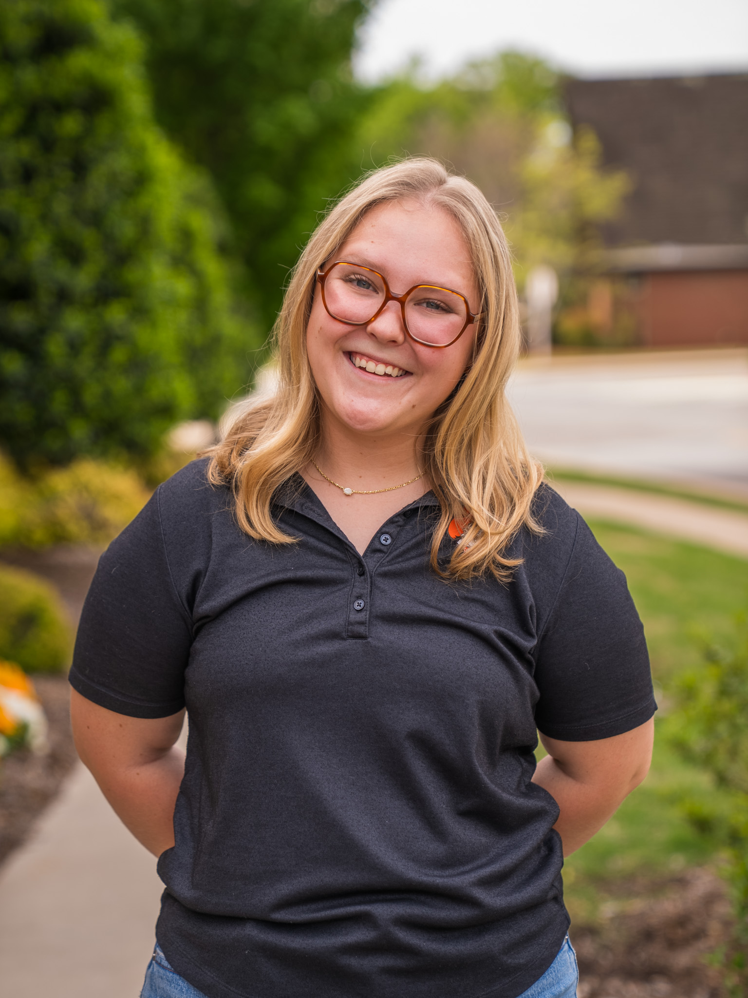 student standing in front of the library