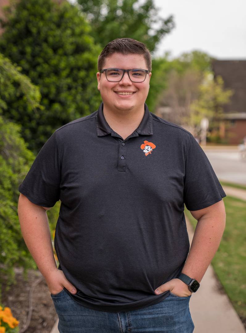 student standing in front of the library