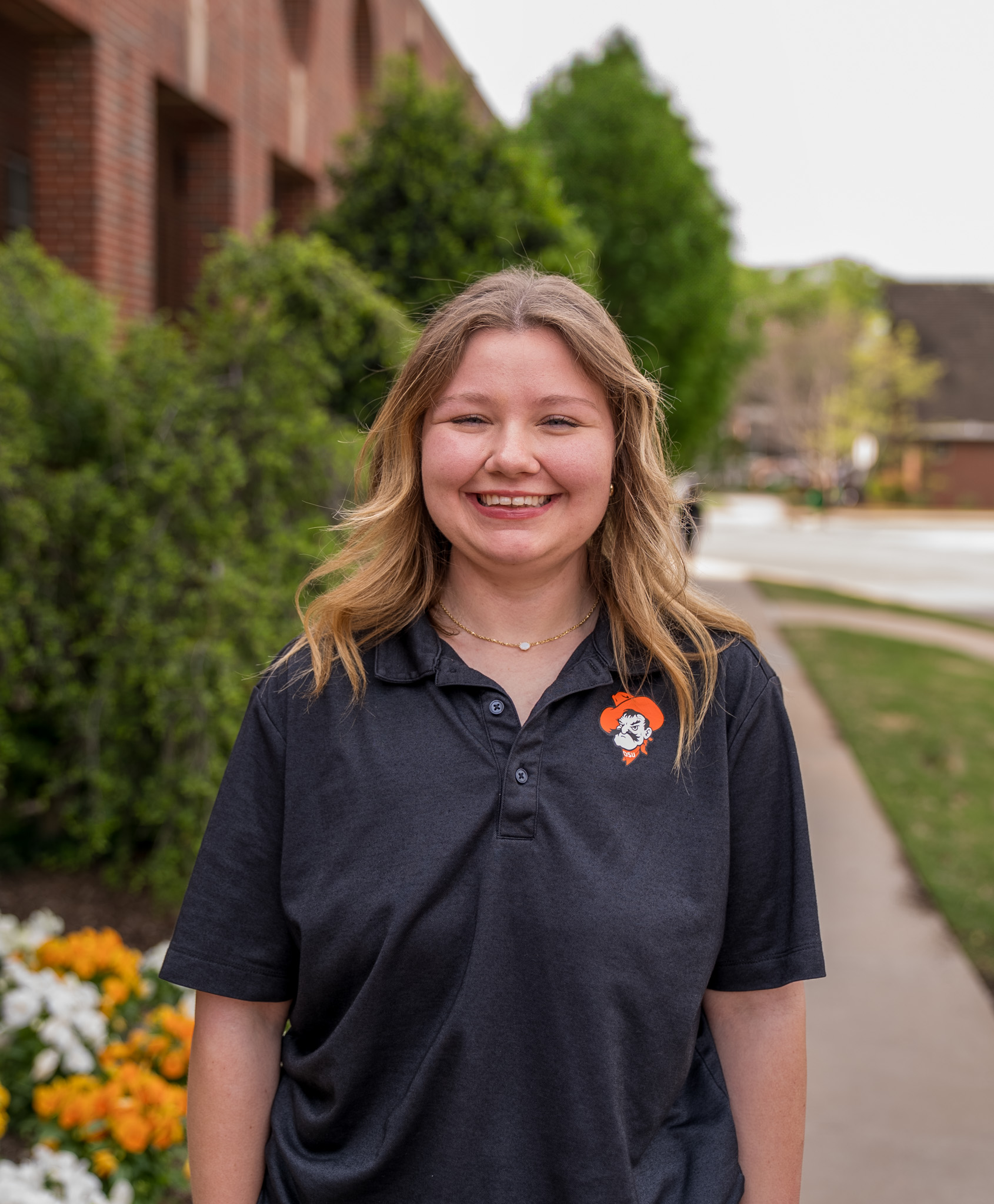 student standing in front of the library