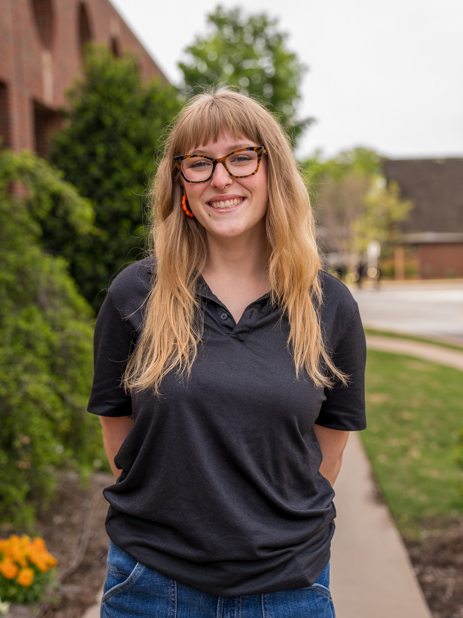 student standing in front of the library