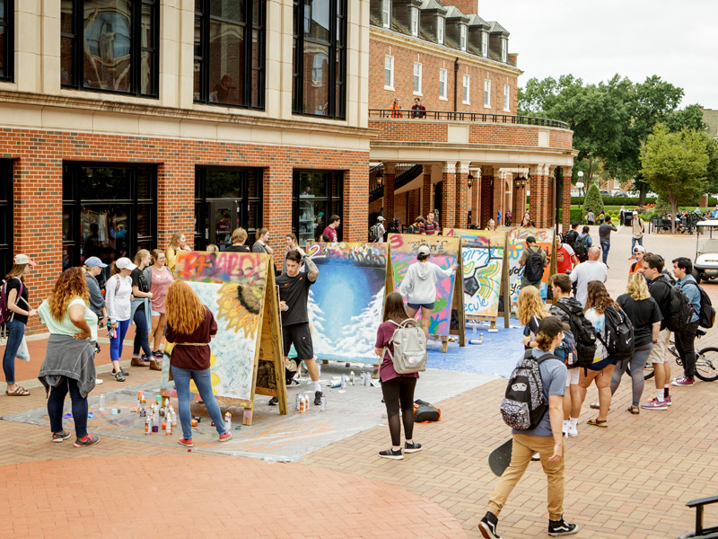 Students participating in an art project outside the Student Union