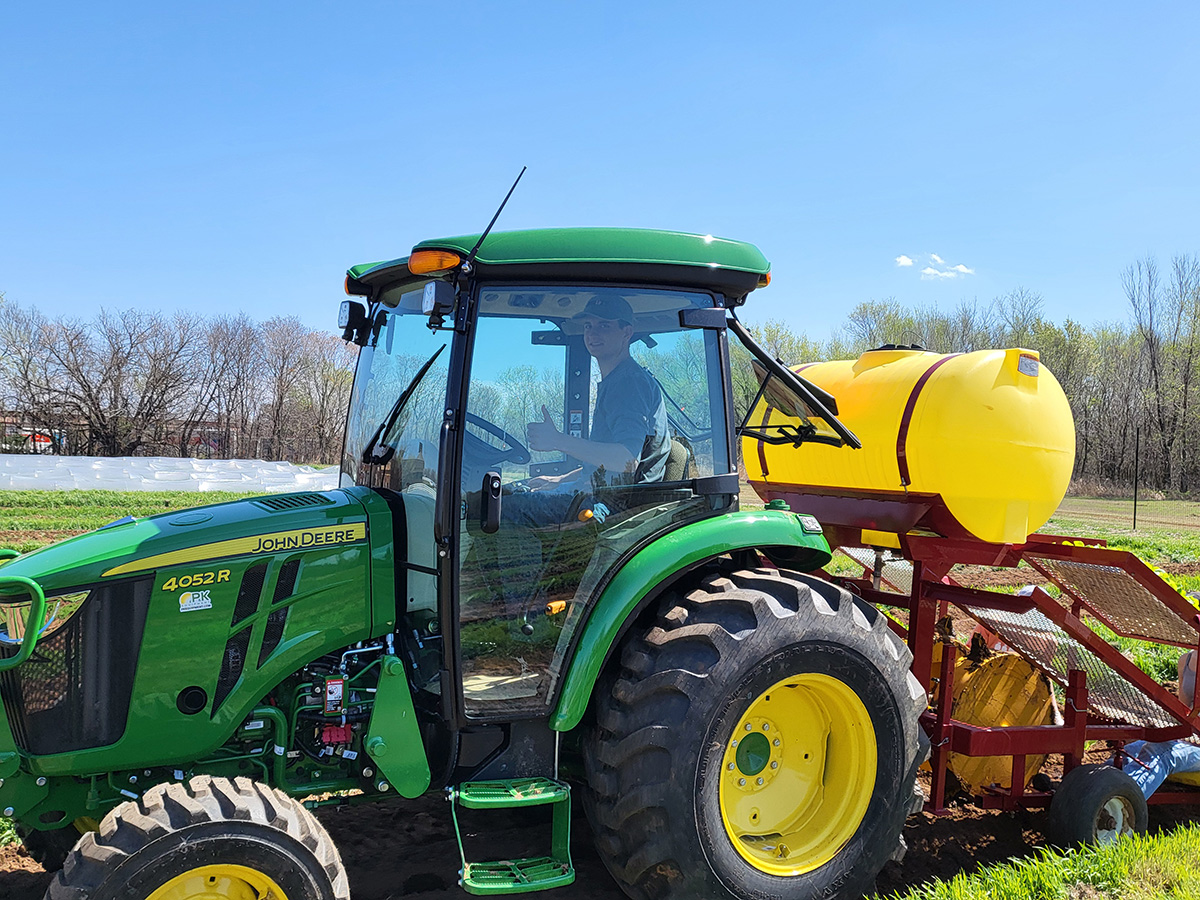 Student worker on tractor