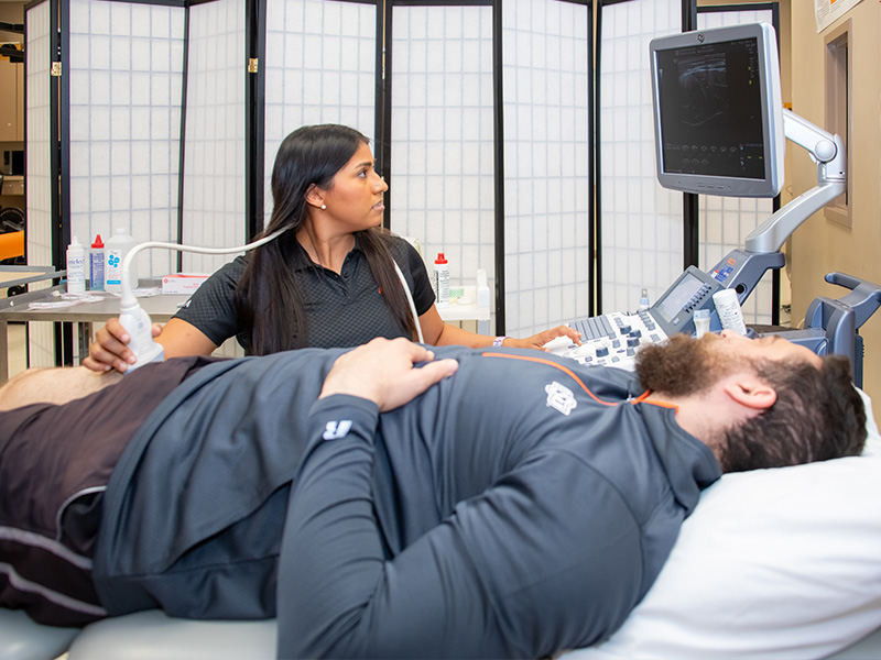 Students performing physical therapy on peer