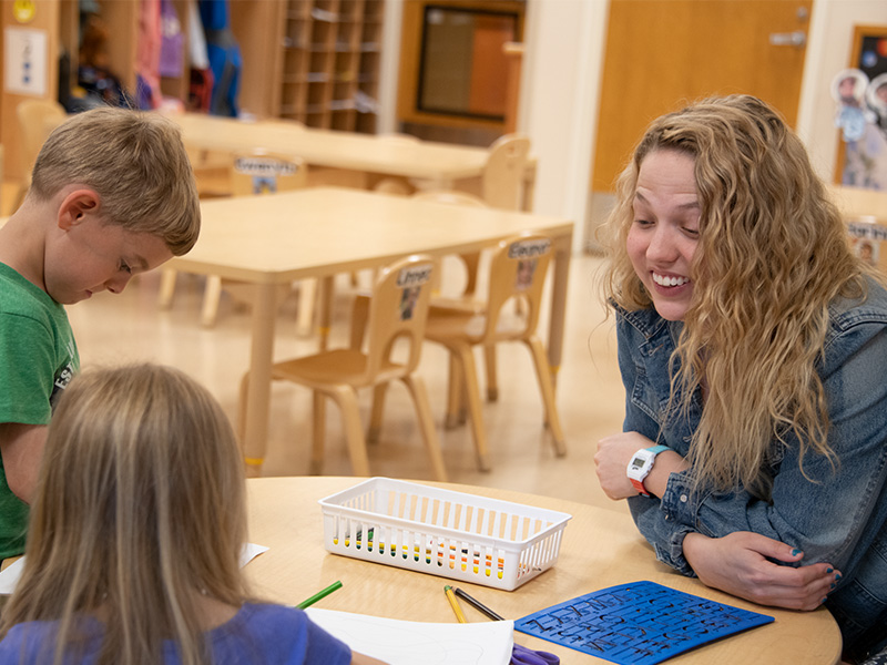 Student working with children in the lab